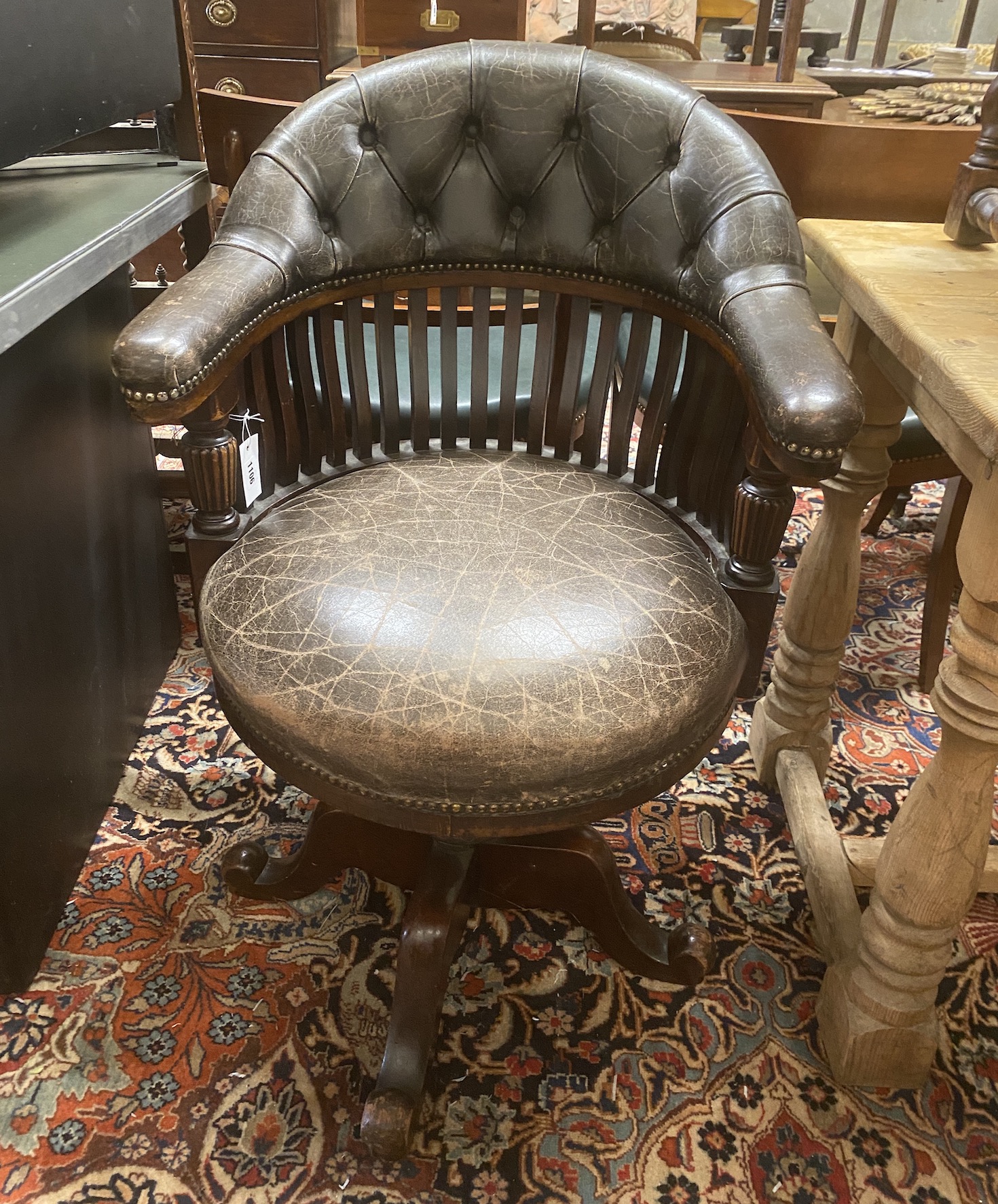 A Victorian mahogany buttoned brown leather swivel desk chair, width 63cm, depth 60cm, height 93cm